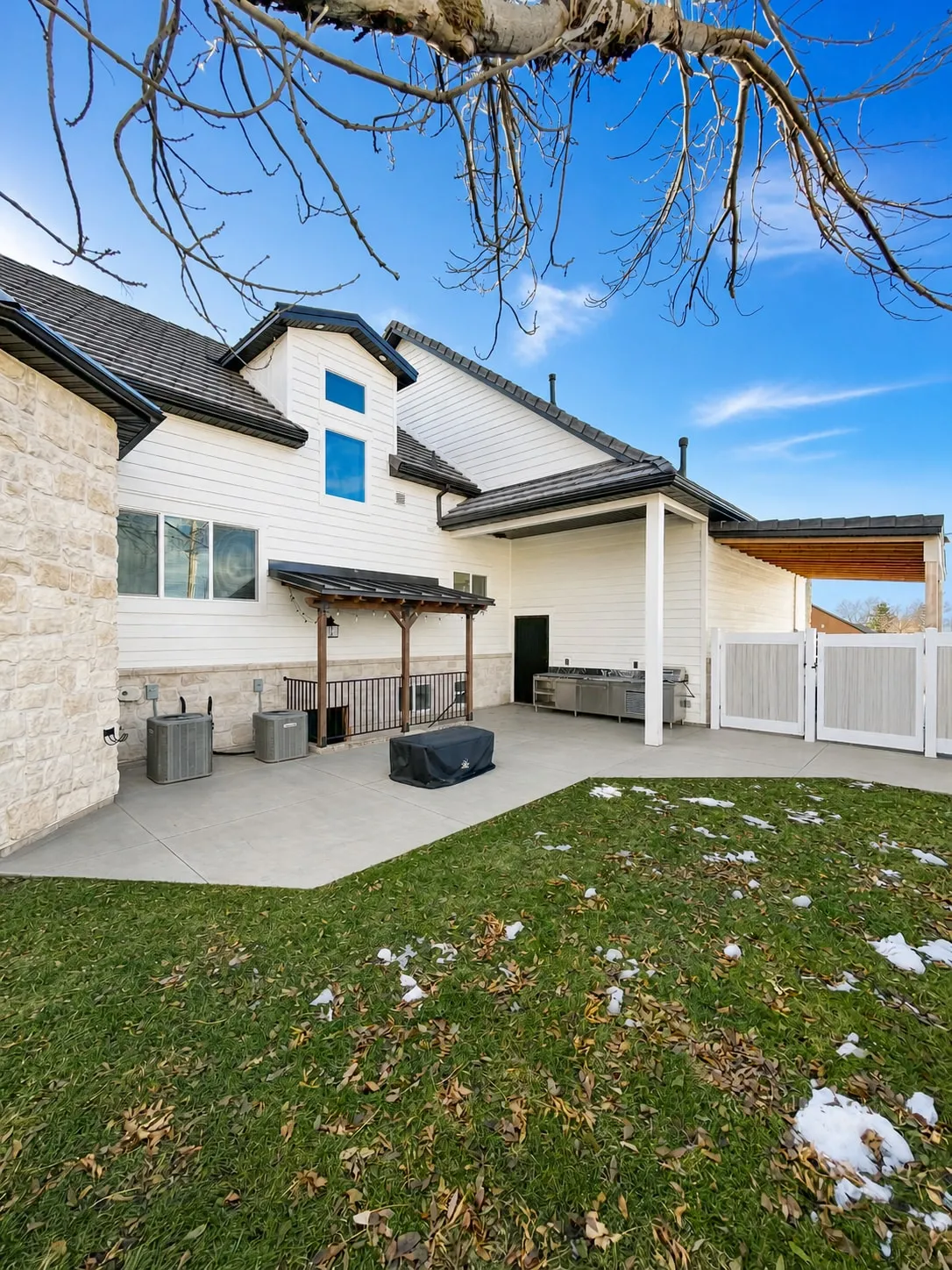 The rebuilt back patio and yard with stone and new exterior finishes