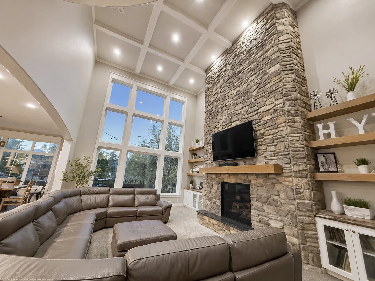 Great room with a full-height stone fireplace and built-ins