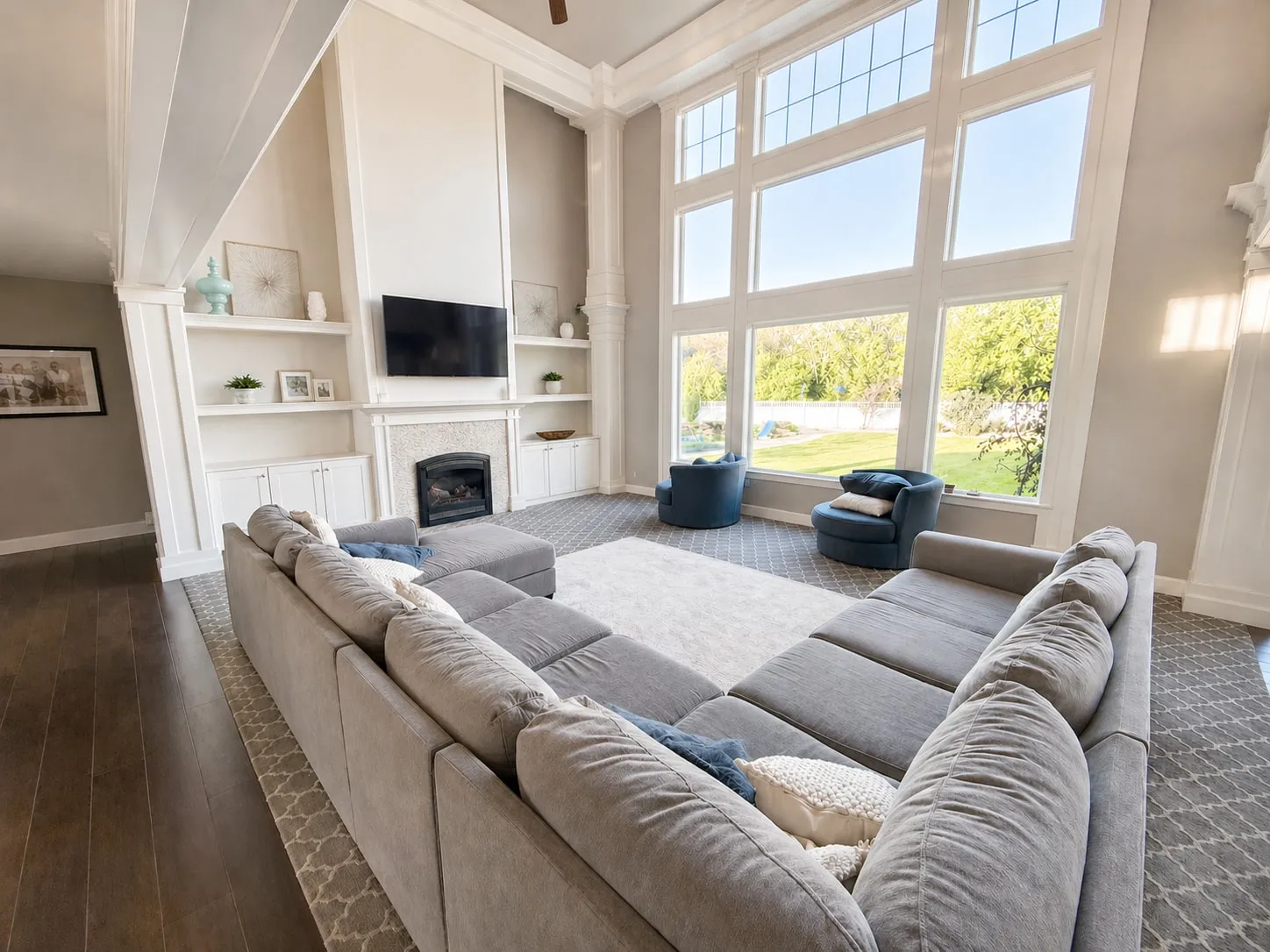 Great room with double-height windows and a sectional facing the view