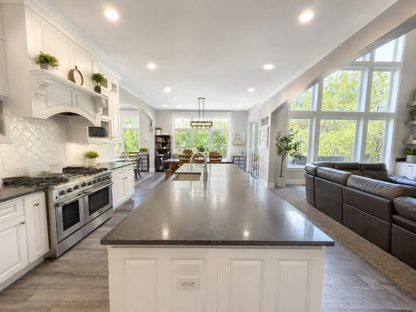 Open kitchen with large island, professional range, and adjoining great room