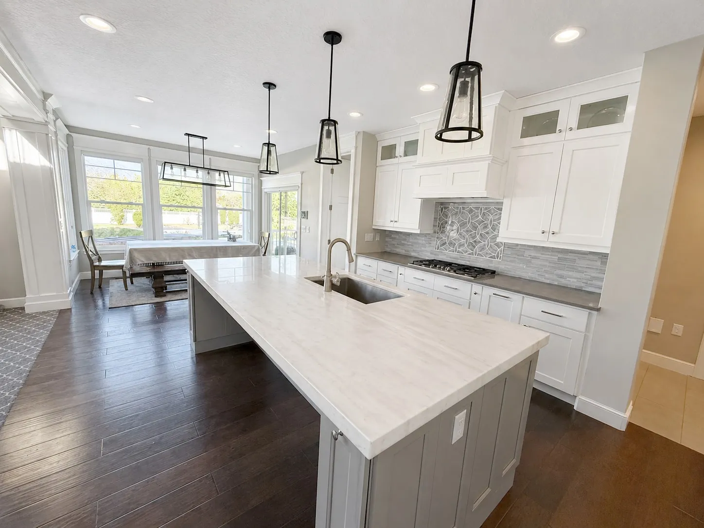 Kitchen with a large island, pendant lighting, and adjoining dining area