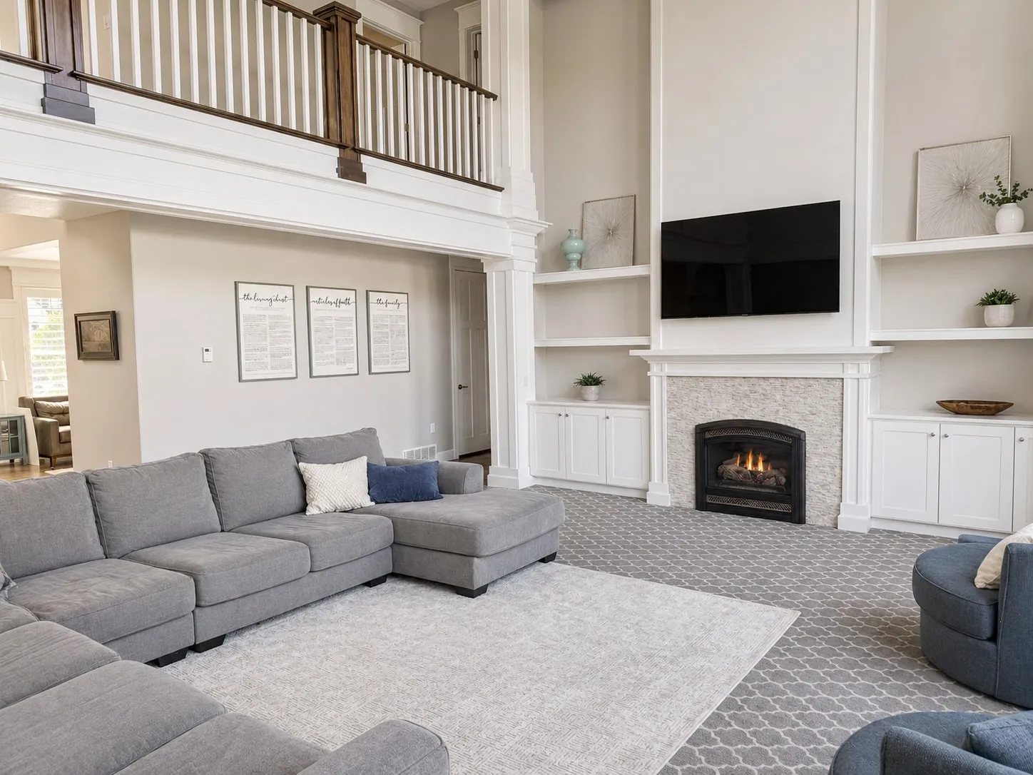 Living room with a fireplace flanked by built-in shelving