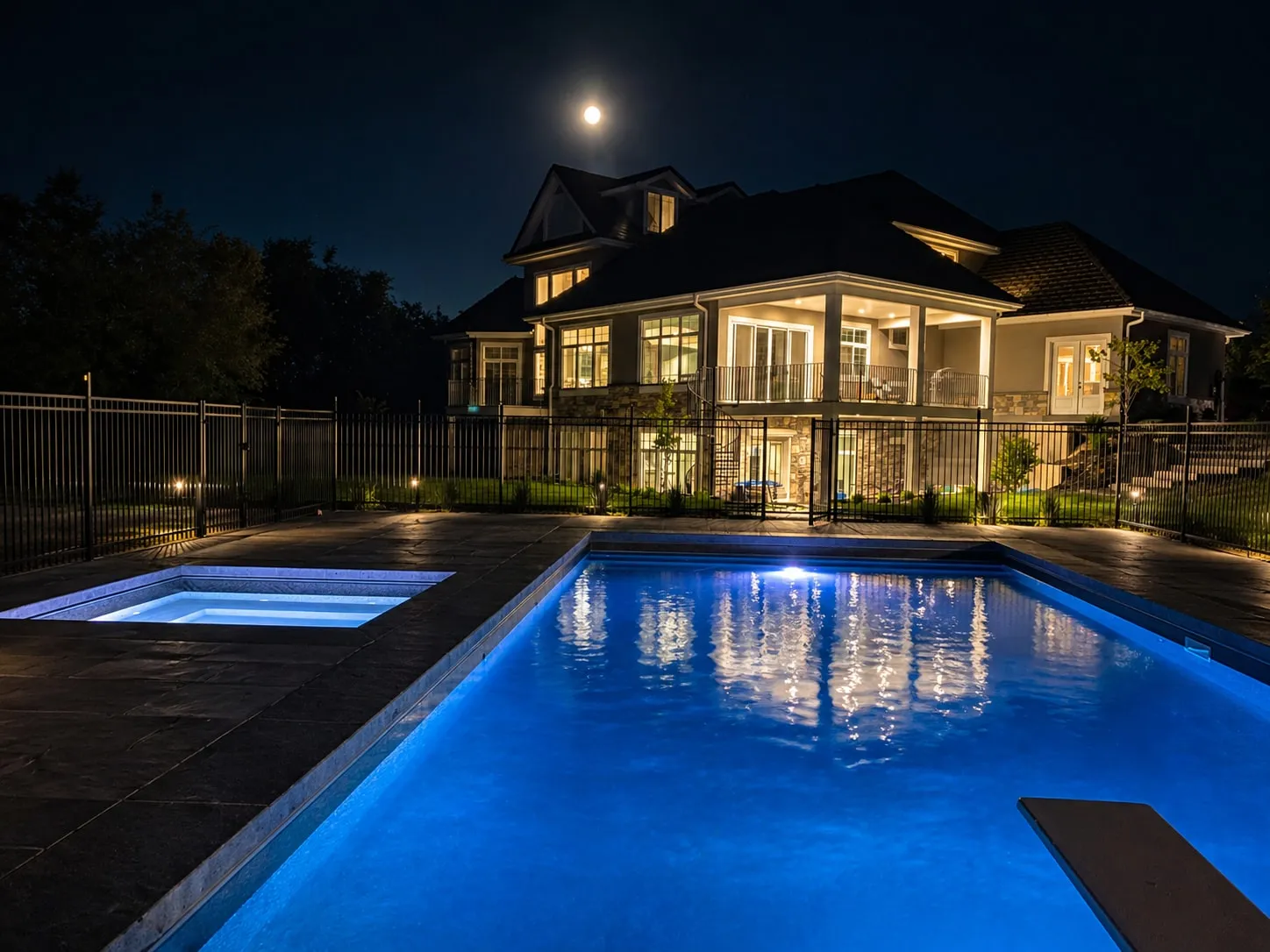 The pool and home lit at twilight