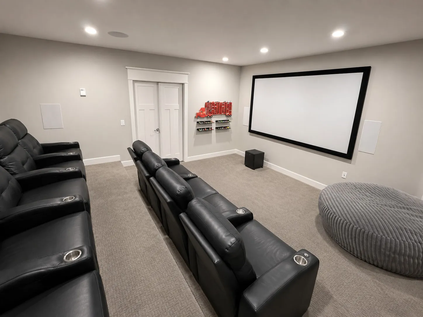 Home theater with tiered recliner seating and a projection screen